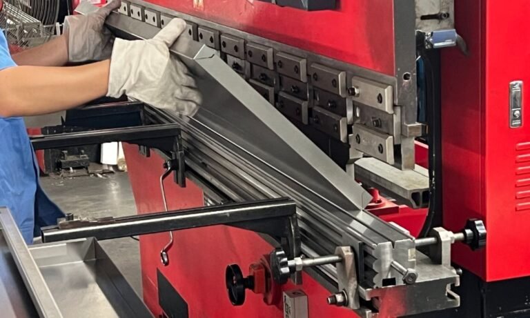 Close-up of Worker Bending Metal Sheets