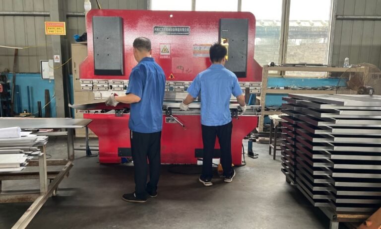 Workers Operating a Bending Machine